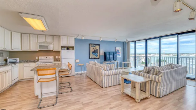 a living room with furniture and a large window with balcony view