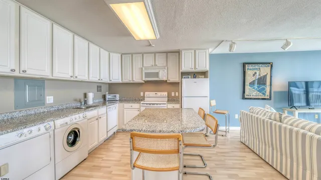 a living room with furniture and large window with balcony view
