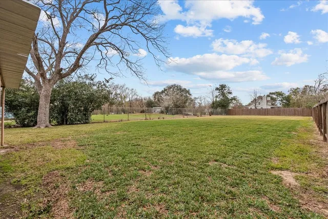 a view of outdoor space with green field and trees