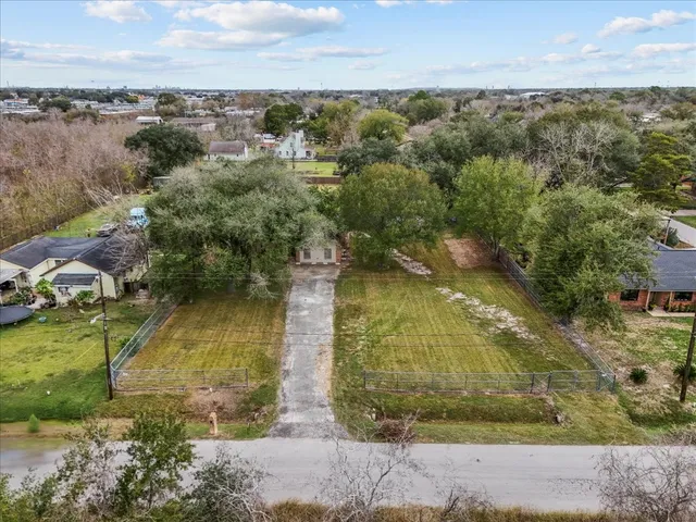 an aerial view of residential houses with outdoor space