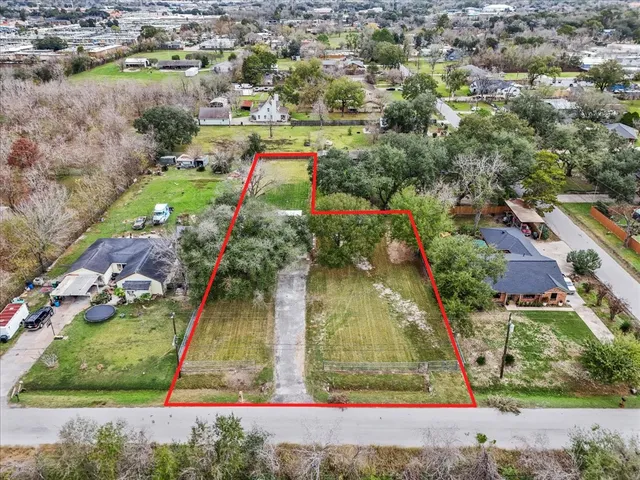 an aerial view of a houses with a yard
