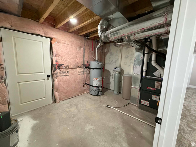 2350 North 1075 West Helper, UT 84526 - Photo 38 of 49 Unfinished basement featuring a water softener, strapped water heater, and heating unit