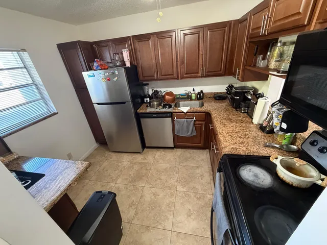 a kitchen with a sink appliances and cabinets