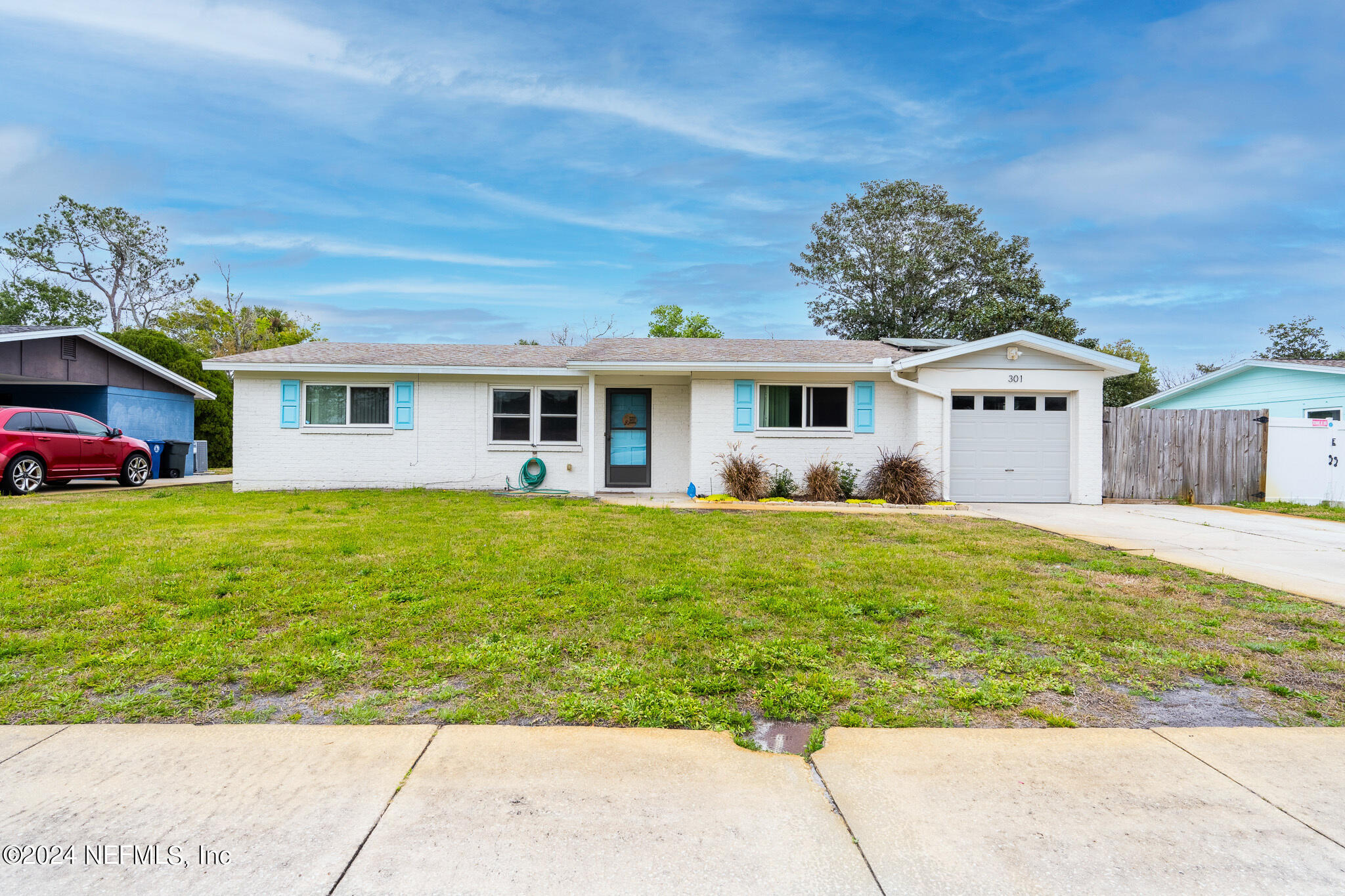 301 Penman Road Neptune Beach, FL 32266 - Photo 1 of 31 a front view of a house with garden
