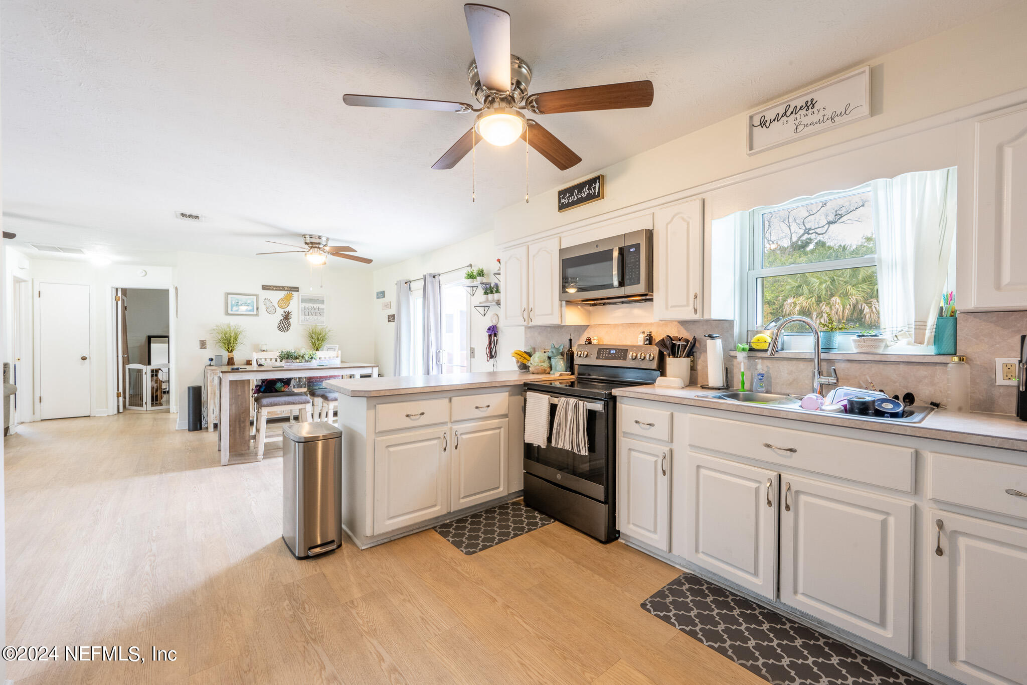 301 Penman Road Neptune Beach, FL 32266 - Photo 11 of 31 a kitchen with sink cabinets and window