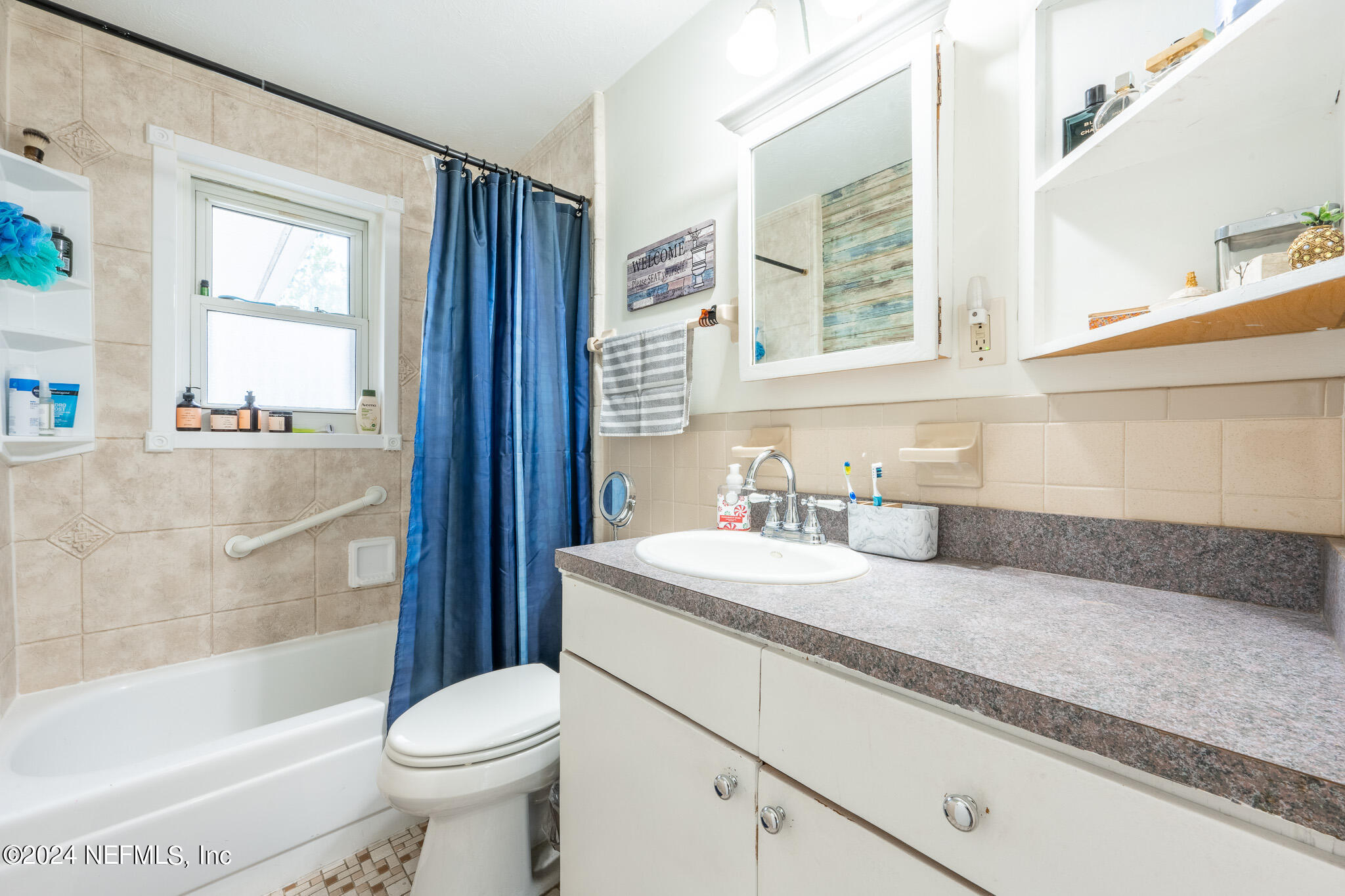 301 Penman Road Neptune Beach, FL 32266 - Photo 16 of 31 a bathroom with a granite countertop sink toilet mirror and bathtub