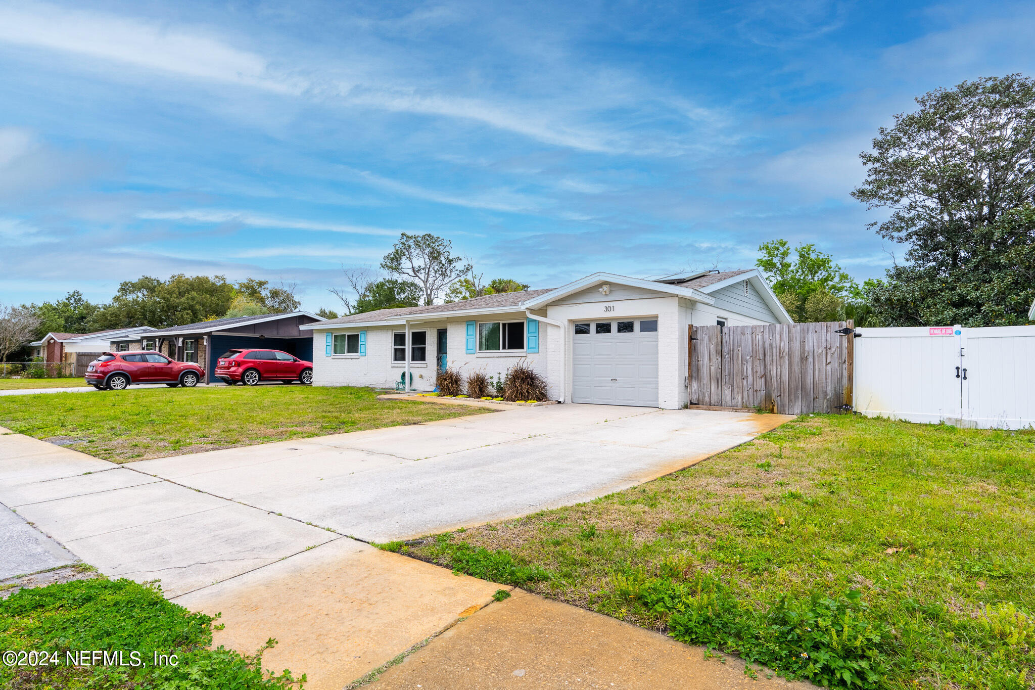 301 Penman Road Neptune Beach, FL 32266 - Photo 2 of 31 a front view of a house with a yard and garage