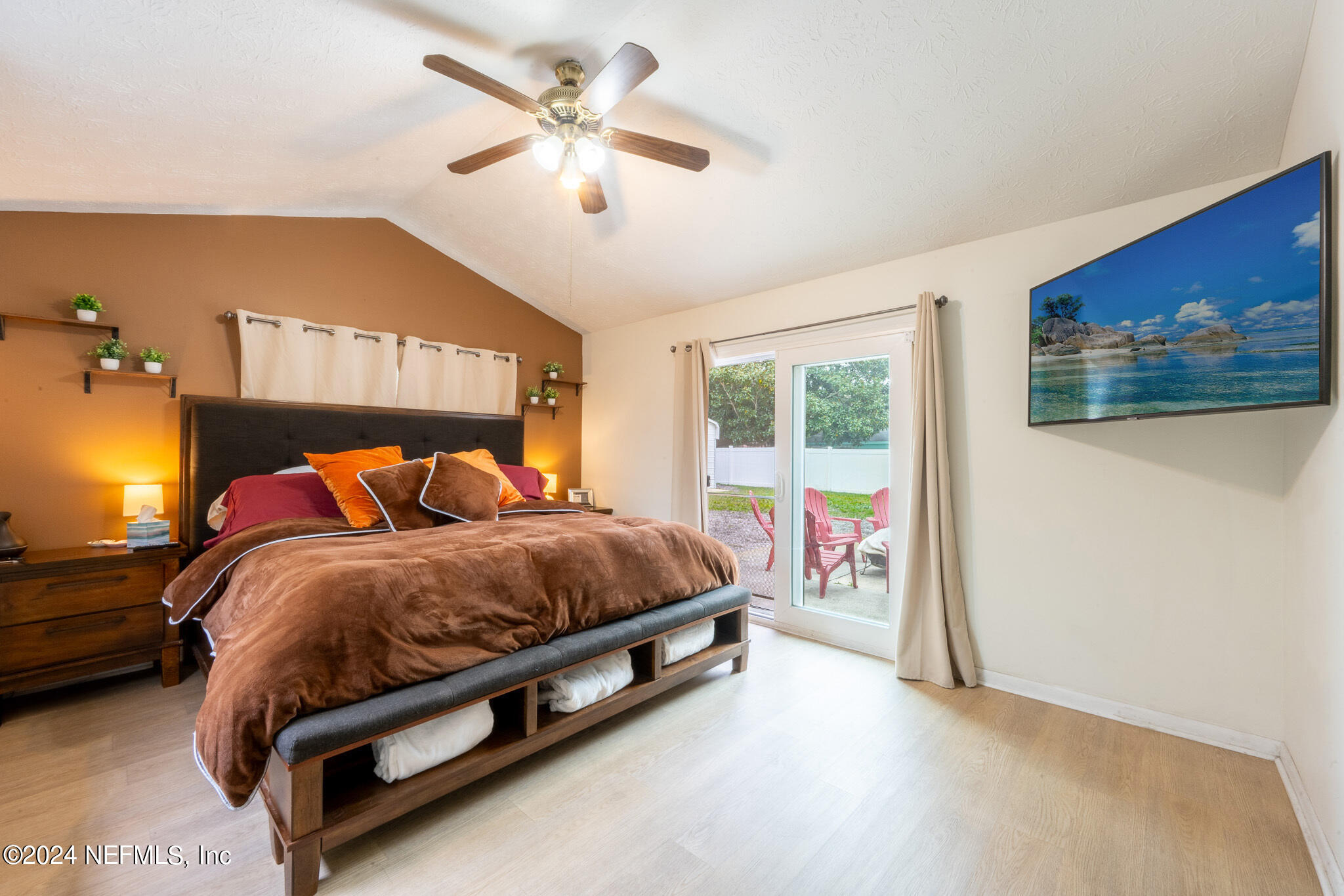 301 Penman Road Neptune Beach, FL 32266 - Photo 21 of 31 a spacious bedroom with a bed and a chandelier