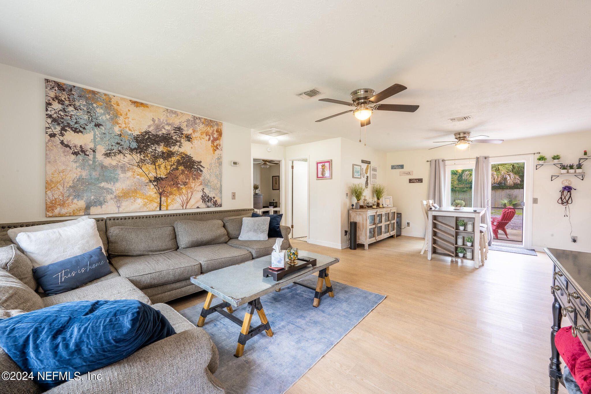 301 Penman Road Neptune Beach, FL 32266 - Photo 8 of 31 a living room with furniture a wooden floor and a chandelier