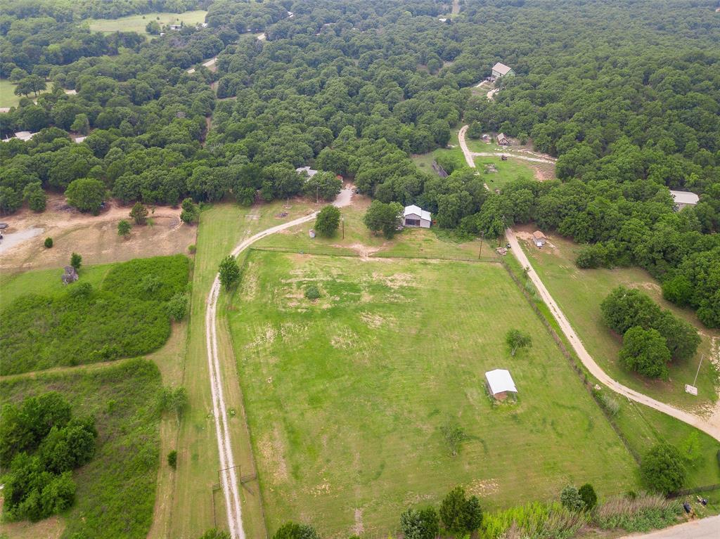 228 Slayden Road Sunset, TX 76270 - Photo 17 of 23 Front pasture with lean-to and 3-stall barn with wash room.