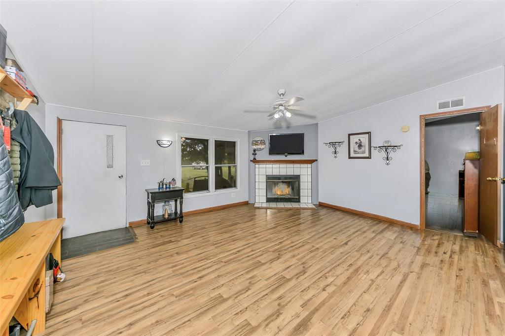 228 Slayden Road Sunset, TX 76270 - Photo 9 of 23 Large living room with corner fireplace.