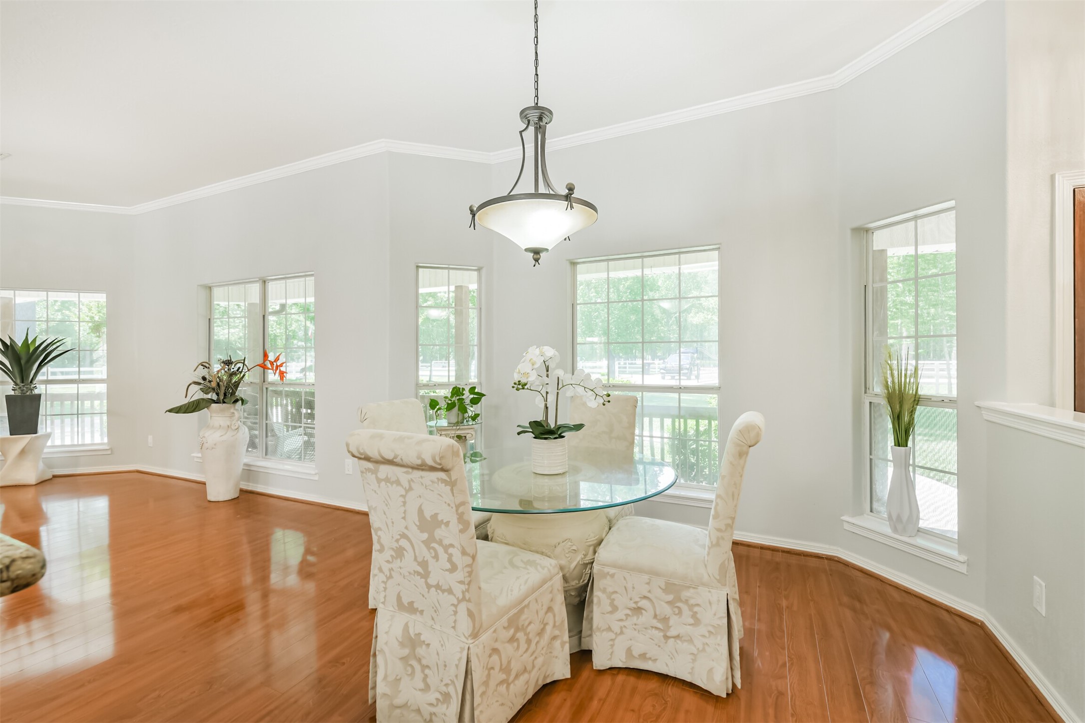 6002 Ranch Park Road Magnolia, TX 77354 - Photo 14 of 49 Bright and inviting dining area with large windows, allowing natural light to fill the space. Perfect for family gatherings or entertaining guests.
