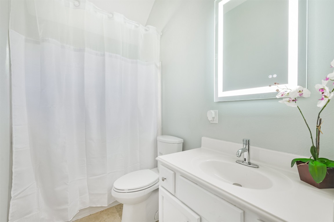 6002 Ranch Park Road Magnolia, TX 77354 - Photo 25 of 49 Bright, modern bathroom with a sleek vanity, illuminated mirror.