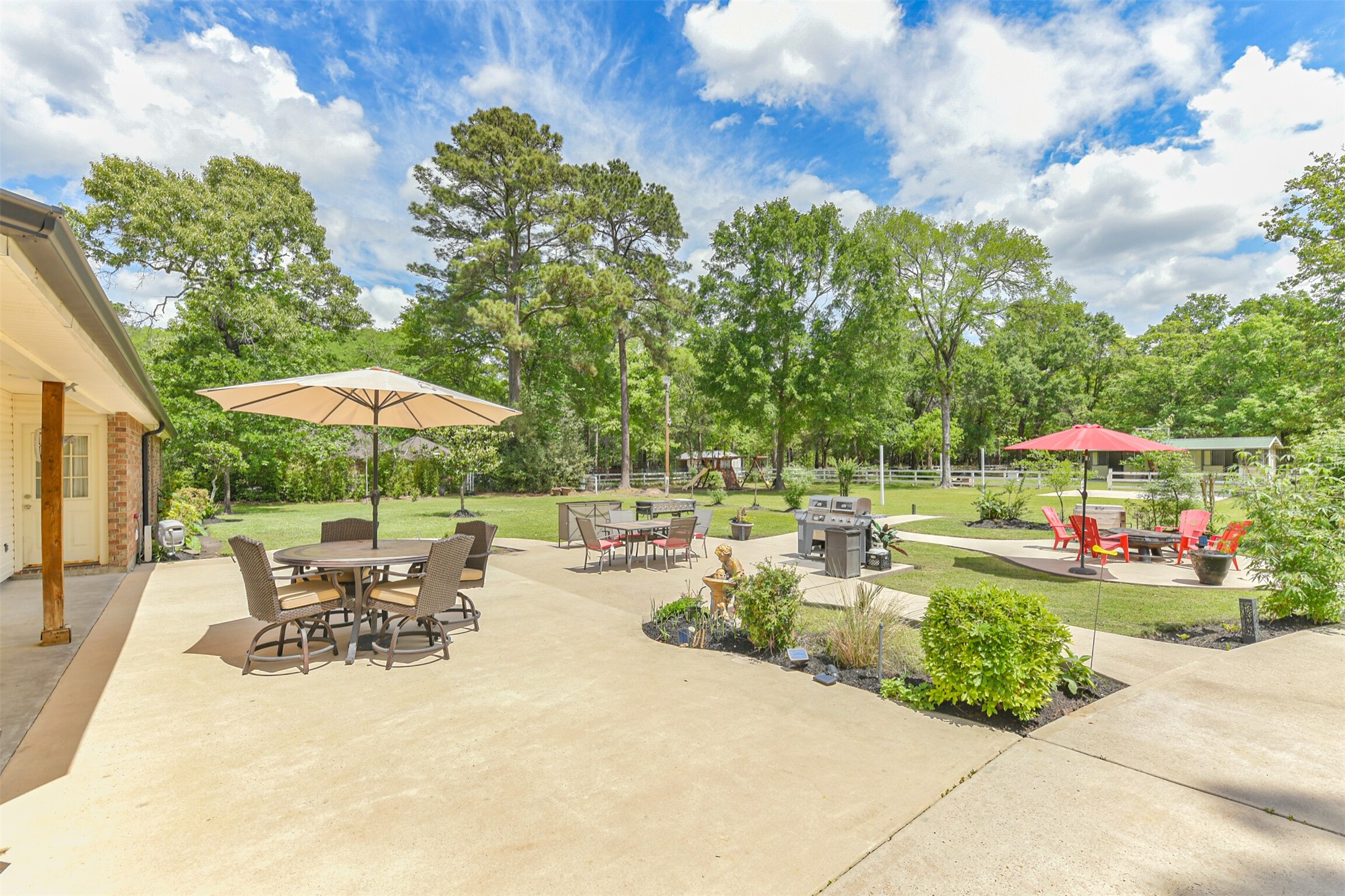 6002 Ranch Park Road Magnolia, TX 77354 - Photo 28 of 49 This spacious backyard features a large patio and lush greenery, ideal for outdoor gatherings and relaxation.