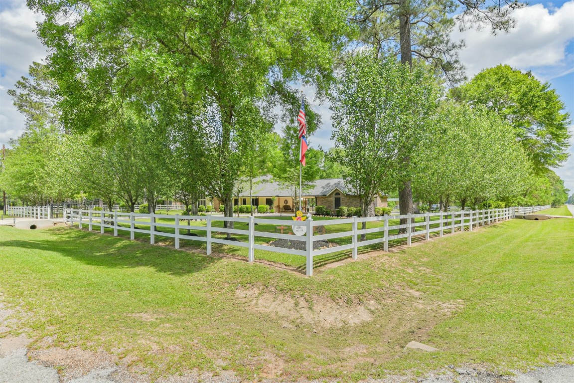 6002 Ranch Park Road Magnolia, TX 77354 - Photo 41 of 49 Charming 1 Story home surrounded by lush greenery and trees, featuring fully fence & Crossed fence and a welcoming front yard. Ideal for those seeking a tranquil, countryside setting.