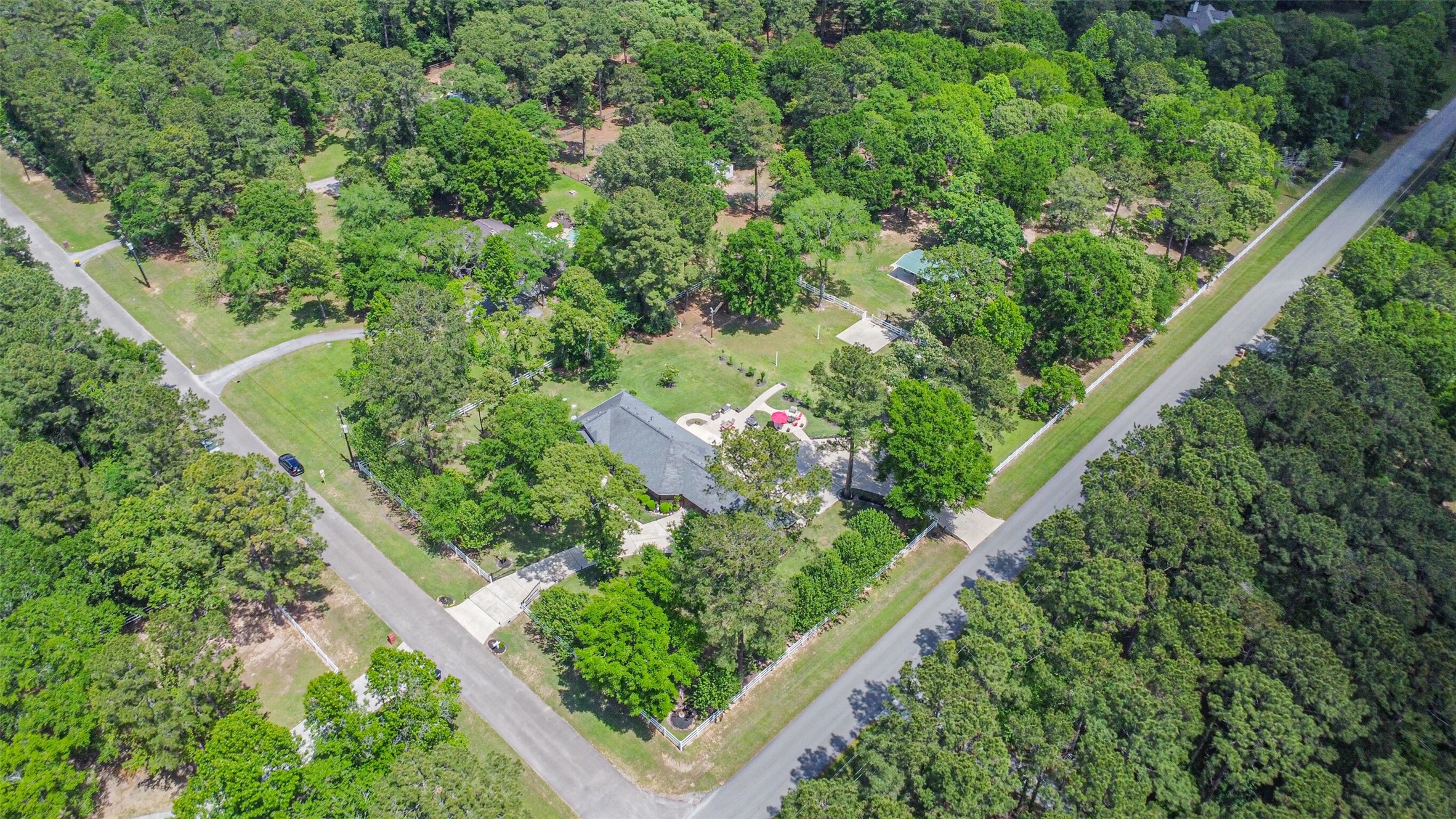 6002 Ranch Park Road Magnolia, TX 77354 - Photo 45 of 49 This aerial photo shows a spacious property surrounded by lush greenery. It’s located at a corner, providing ample privacy and access, ideal for those seeking a serene, nature-filled environment.