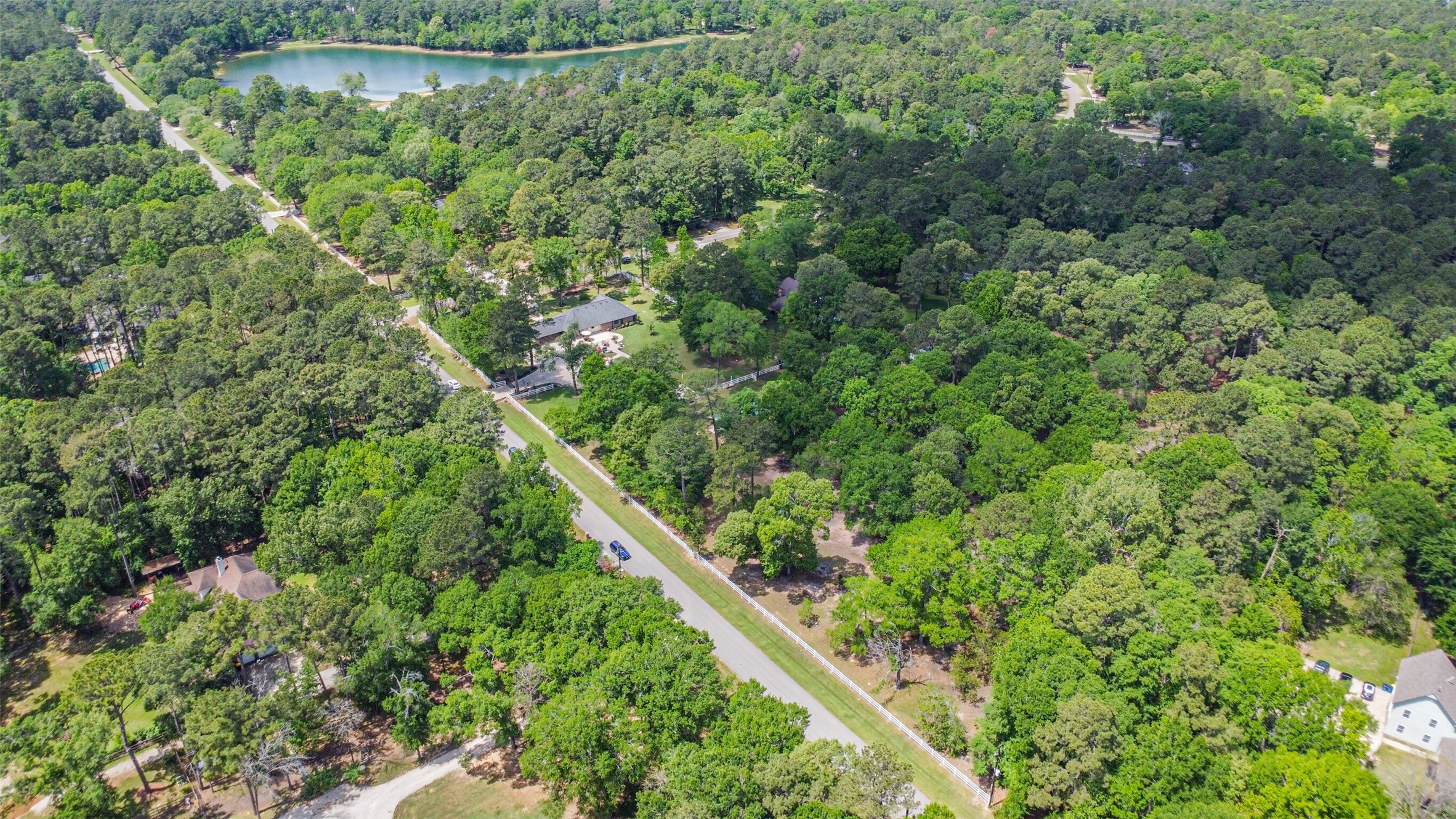 6002 Ranch Park Road Magnolia, TX 77354 - Photo 47 of 49 This aerial photo showcases neighborhood, stocked 12-acre lake with a walking trail; perfect for fishing, canoeing, and paddleboarding .