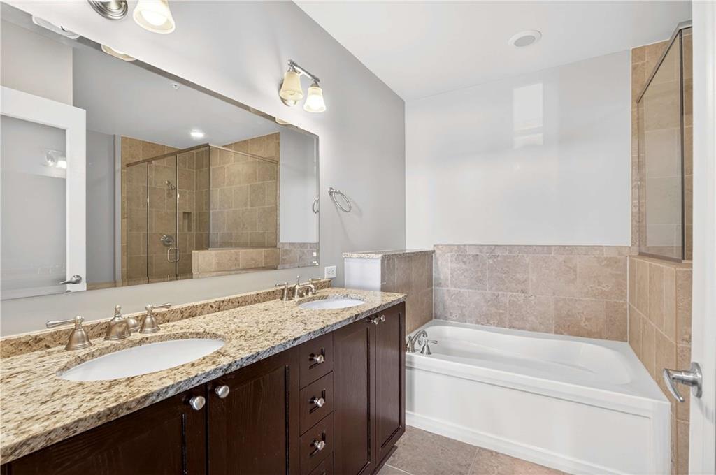 201 West Ponce De Leon Avenue, Unit 702 Decatur, GA 30030 - Photo 19 of 41 a bathroom with a granite countertop bathtub sink double and mirror