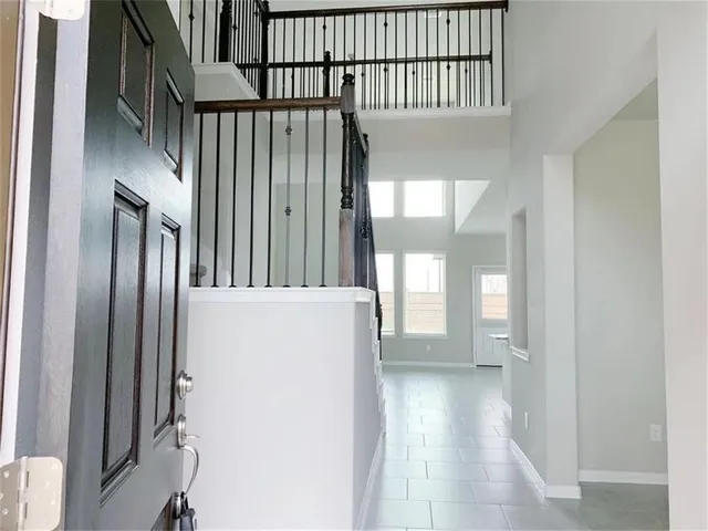 a view of staircase with railing and a window