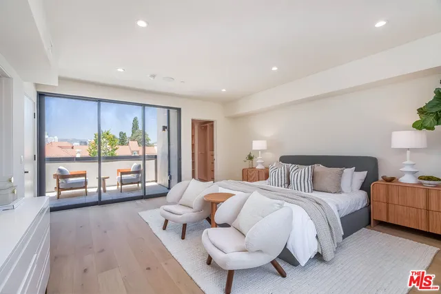 a spacious bedroom with a bed and a couch