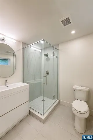 a bathroom with a toilet a sink and a mirror
