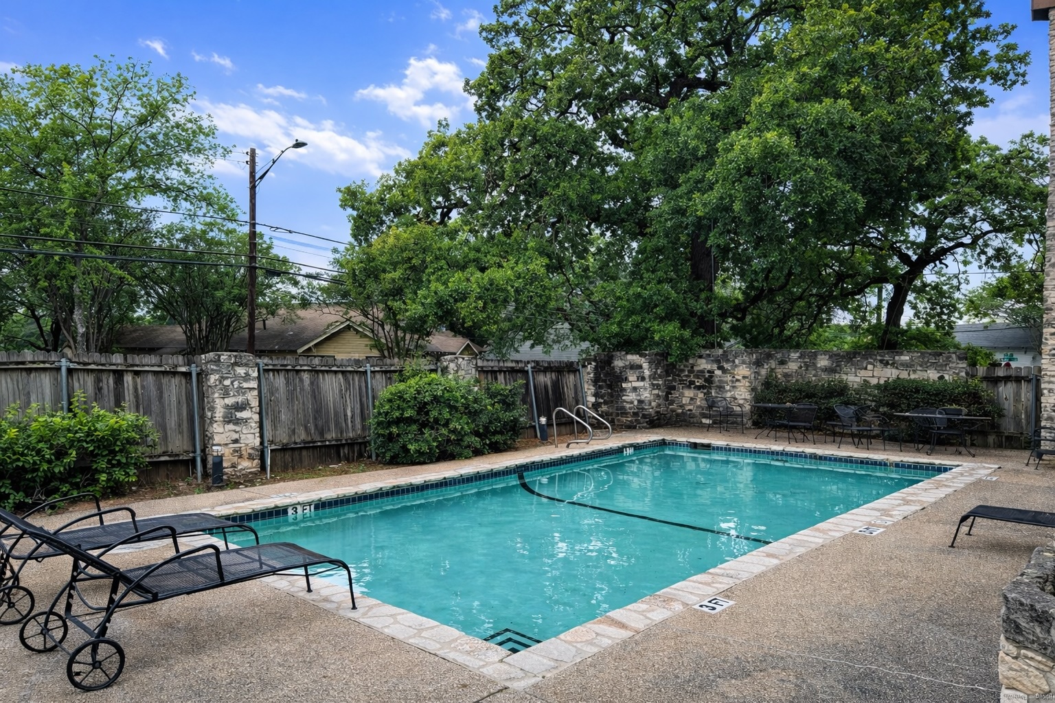 808 West 29th Street, Unit 206 Austin, TX 78705 - Photo 12 of 17 a view of a swimming pool with a patio and a yard
