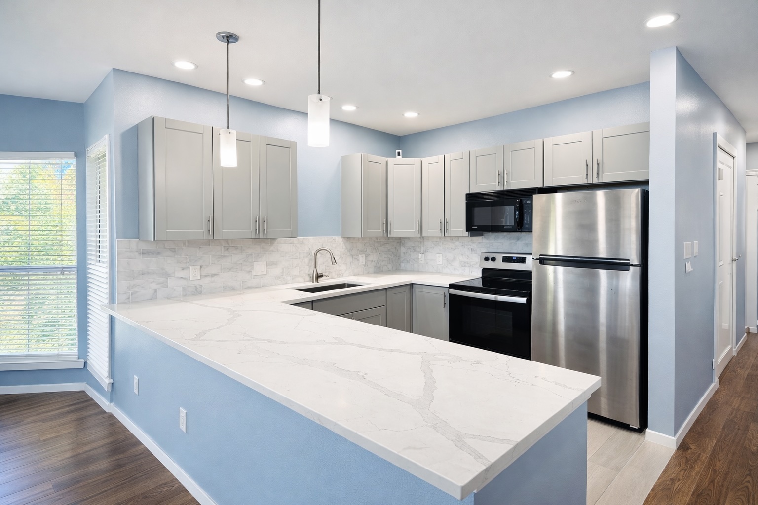 808 West 29th Street, Unit 206 Austin, TX 78705 - Photo 3 of 17 a large kitchen with stainless steel appliances kitchen island a large counter top and a refrigerator