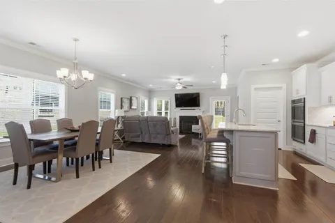 a living room with furniture and kitchen view