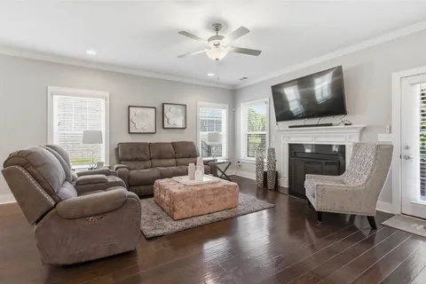a kitchen with stainless steel appliances a dining table chairs stove and cabinets