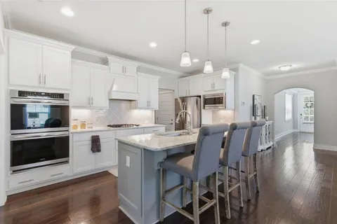 a kitchen with granite countertop cabinets and steel stainless steel appliances