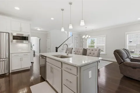 a kitchen with stainless steel appliances granite countertop a refrigerator sink and stove