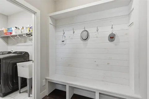 a white bath tub sitting in a bathroom next to a window