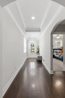 a view of a hallway with wooden floor and staircase