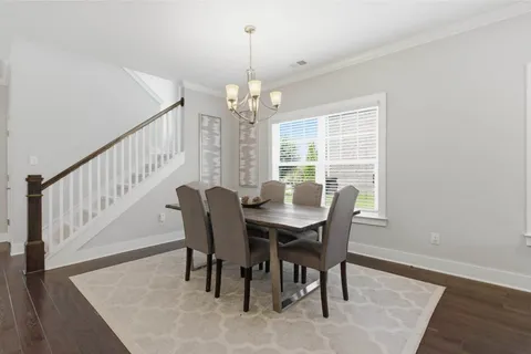 a large kitchen with a table and chairs