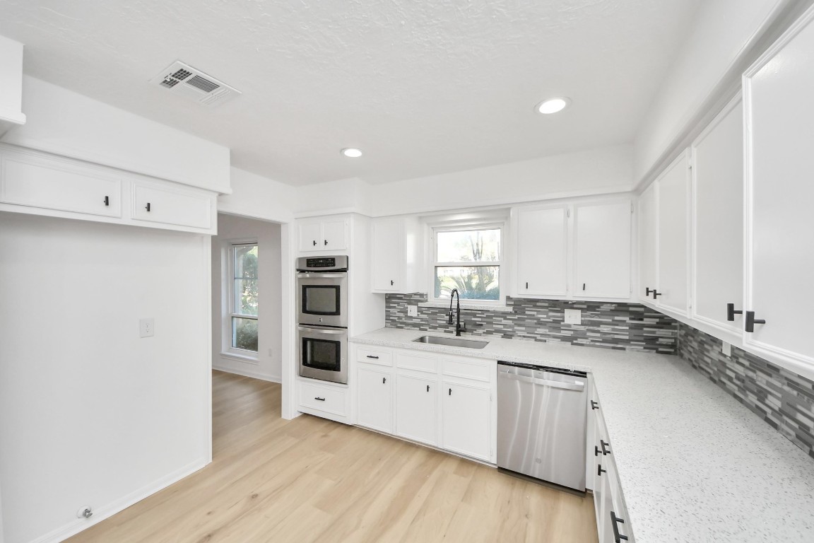 18803 Oakway Drive Spring, TX 77388 - Photo 11 of 47 a kitchen with stainless steel appliances granite countertop a sink and cabinets