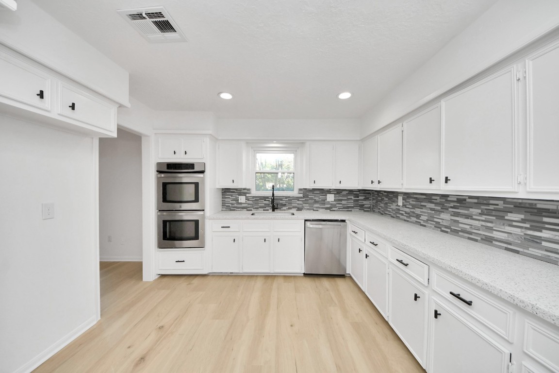 18803 Oakway Drive Spring, TX 77388 - Photo 12 of 47 a kitchen with granite countertop white cabinets and white appliances