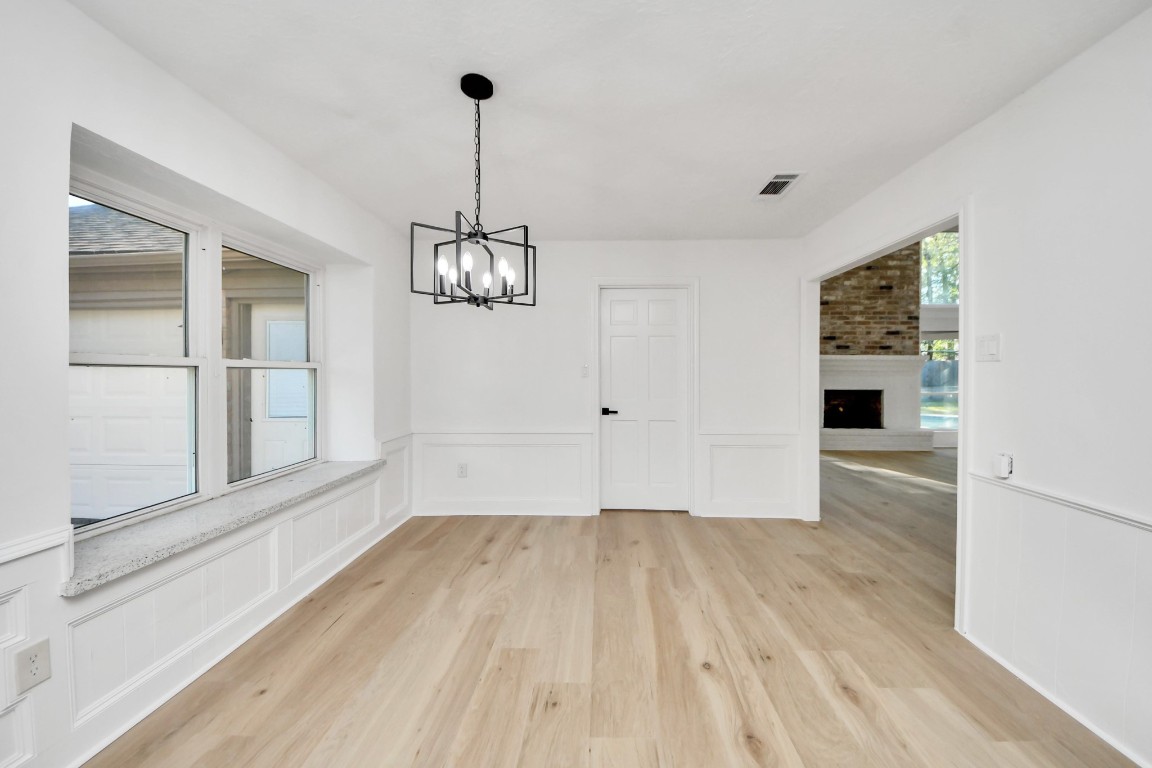 18803 Oakway Drive Spring, TX 77388 - Photo 15 of 47 a view of empty room with wooden floor and fan