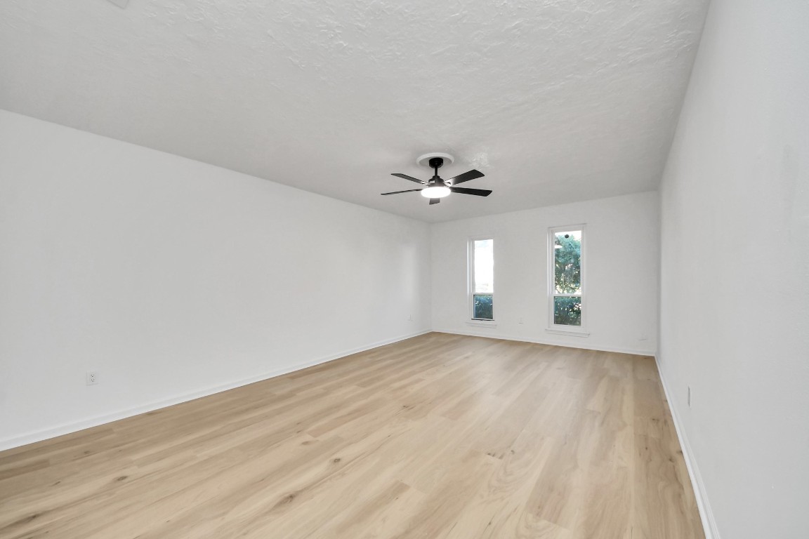 18803 Oakway Drive Spring, TX 77388 - Photo 22 of 47 a view of an empty room with window and wooden floor