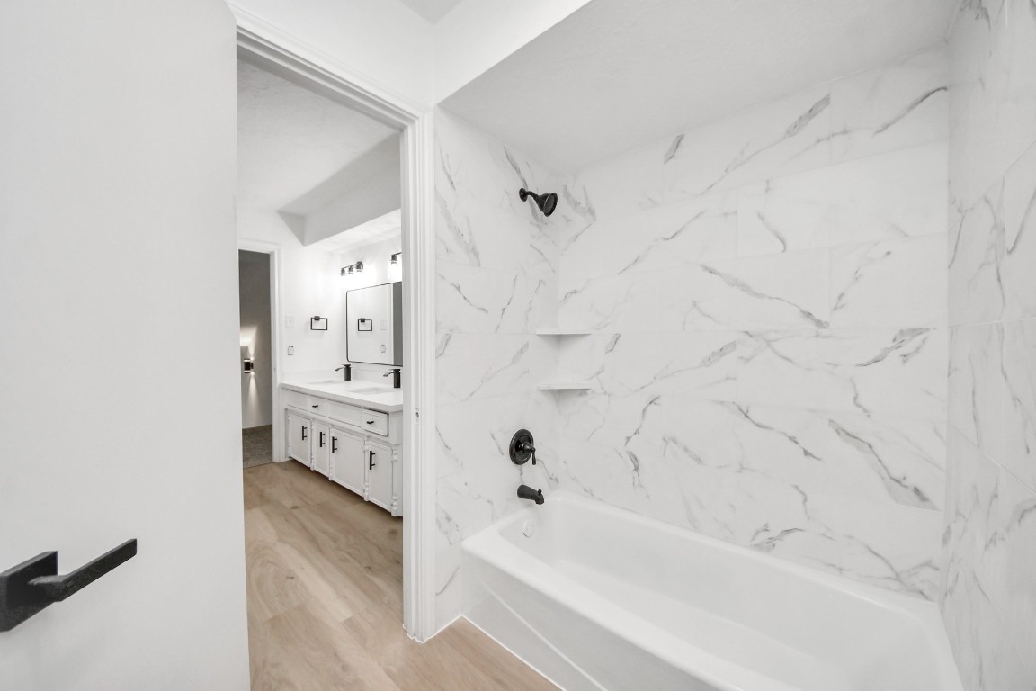 18803 Oakway Drive Spring, TX 77388 - Photo 32 of 47 a bathroom with a bathtub and a shower