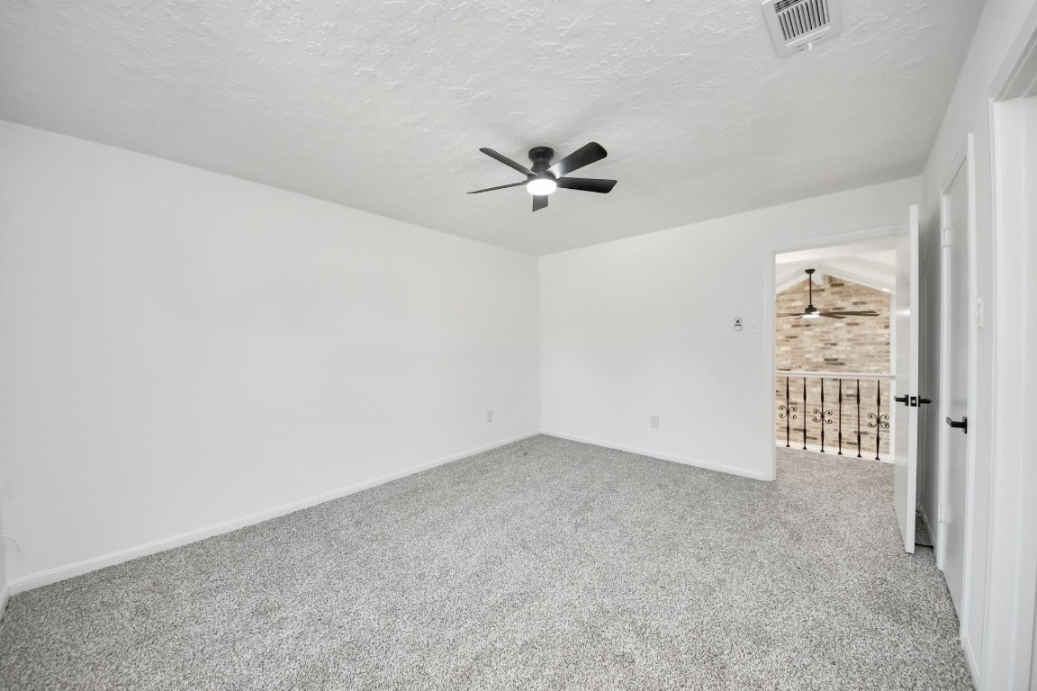 18803 Oakway Drive Spring, TX 77388 - Photo 34 of 47 an empty room with windows and ceiling fan view