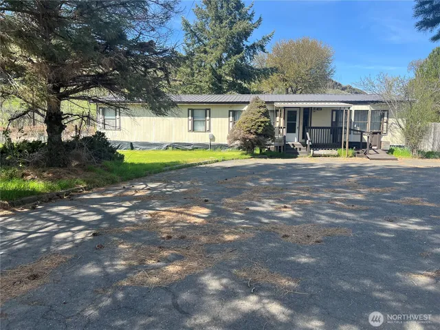 a front view of a house with a garden and porch
