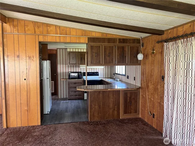 a kitchen with stainless steel appliances granite countertop a stove and a refrigerator
