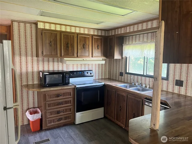a kitchen with stainless steel appliances granite countertop a stove and a sink