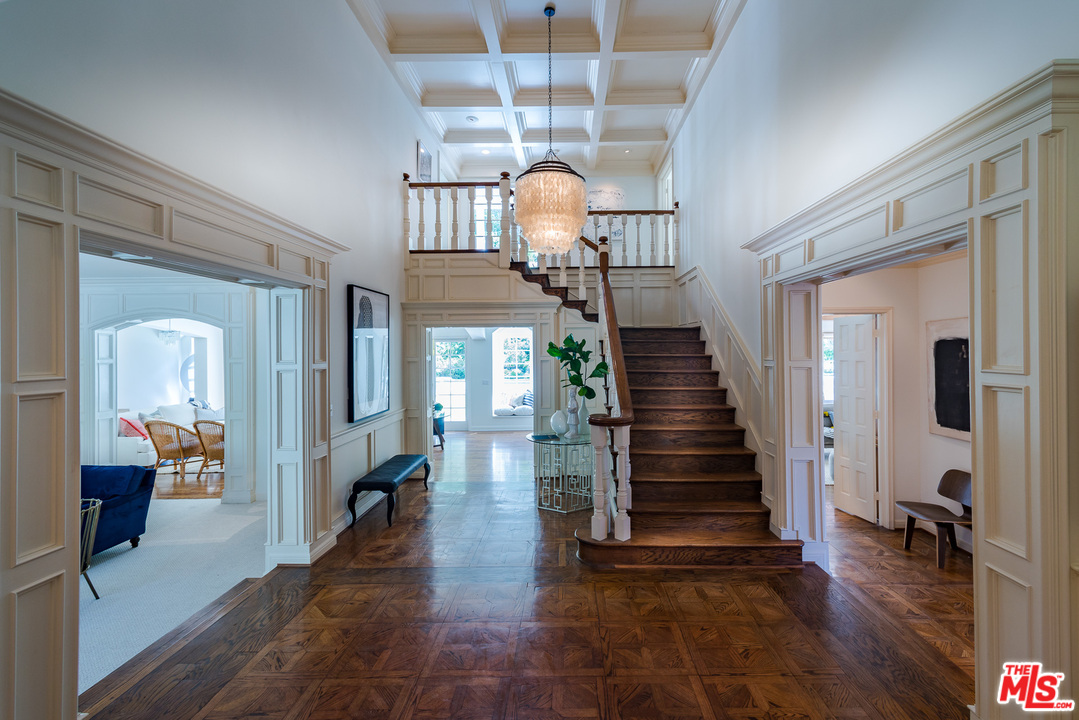1420 Moraga Drive Los Angeles, CA 90049 - Photo 2 of 38 a view of a hallway to a livingroom with wooden floor staircase and a kitchen