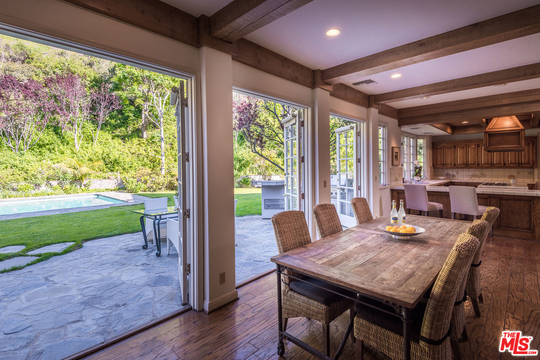 1420 Moraga Drive Los Angeles, CA 90049 - Photo 11 of 38 a view of a dining room with furniture window and wooden floor