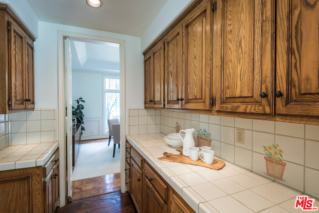 1420 Moraga Drive Los Angeles, CA 90049 - Photo 15 of 38 a kitchen with granite countertop a sink a stove and cabinets