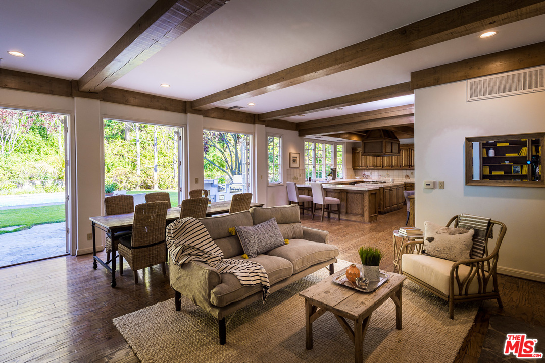 1420 Moraga Drive Los Angeles, CA 90049 - Photo 16 of 38 a living room with furniture and floor to ceiling windows