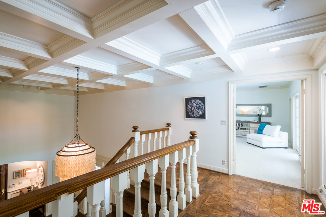1420 Moraga Drive Los Angeles, CA 90049 - Photo 18 of 38 a view of a hallway to a livingroom and a dining room with wooden floor