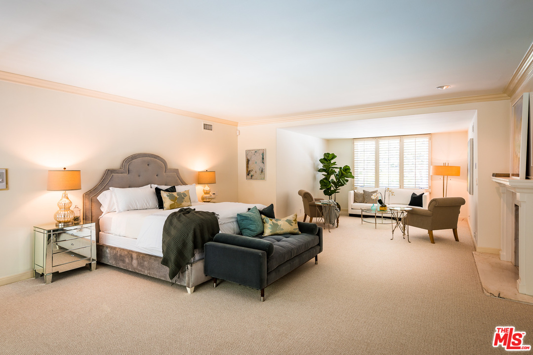 1420 Moraga Drive Los Angeles, CA 90049 - Photo 20 of 38 a spacious bedroom with a bed and a couch
