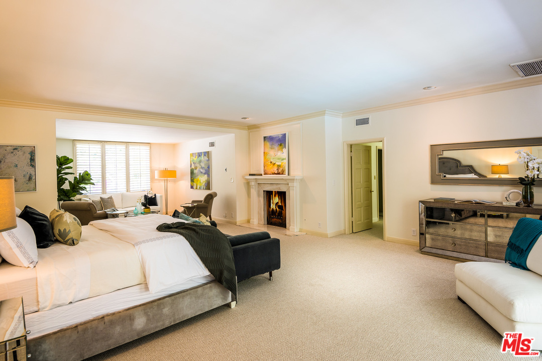 1420 Moraga Drive Los Angeles, CA 90049 - Photo 21 of 38 a bedroom with bed couch and window